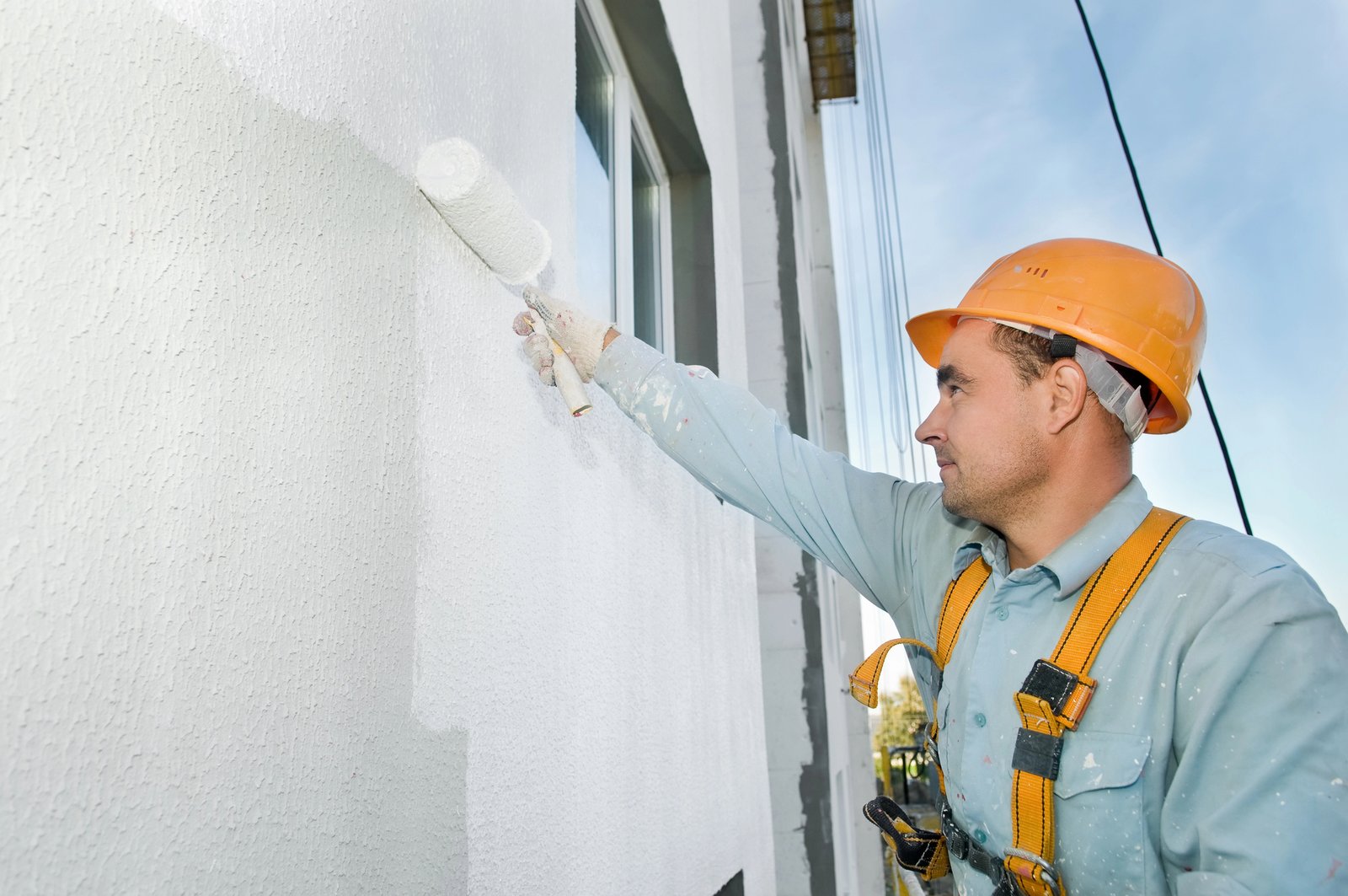 Professional painter ensuring a durable and vibrant finish on a home exterior in King County with precision and care